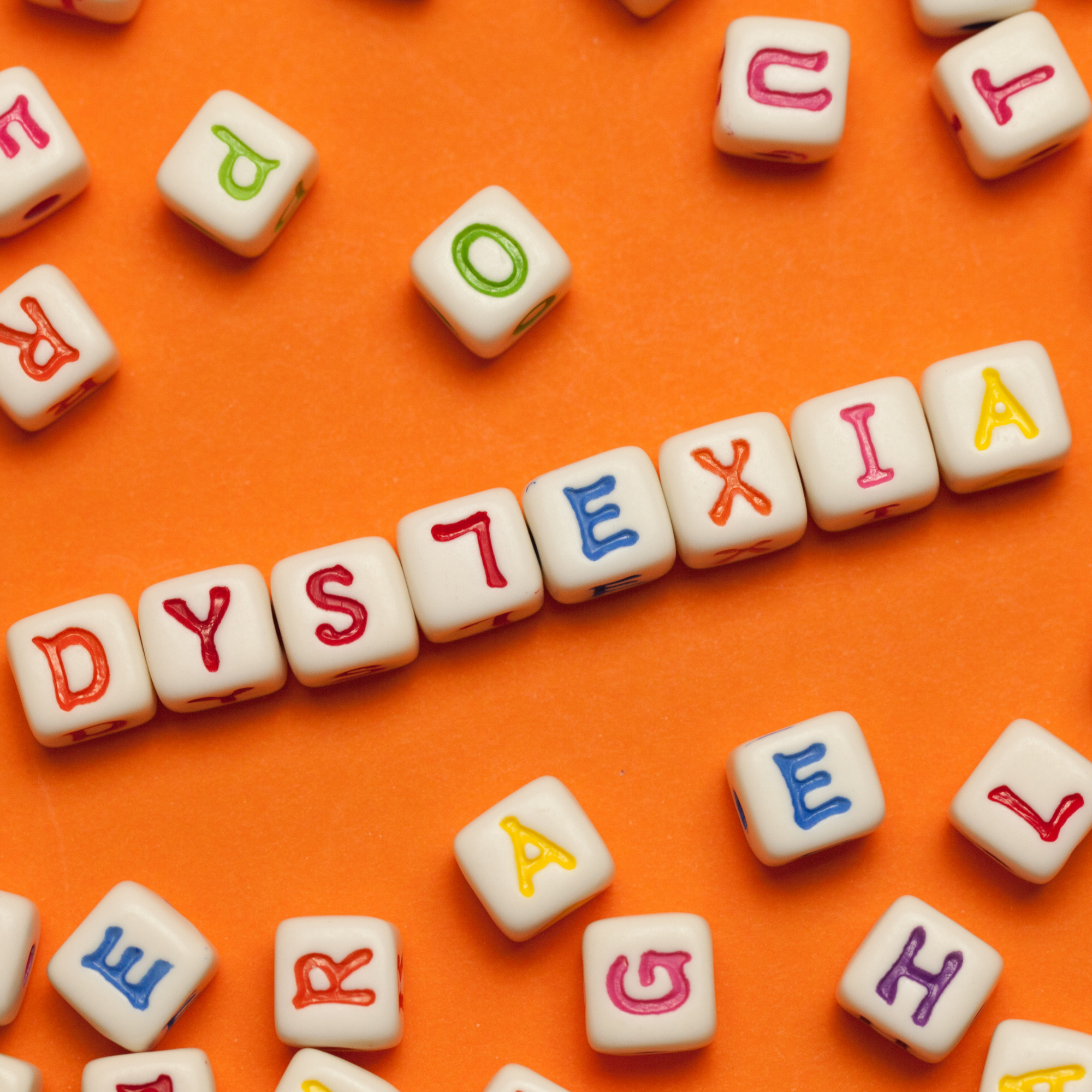 Young girl smiling at the library with an open book